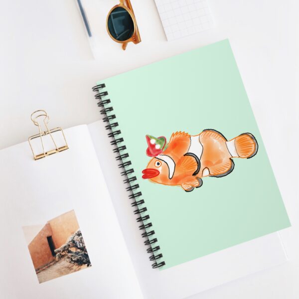 Bright orange clown fish printed on a coastal-themed spiral notebook
