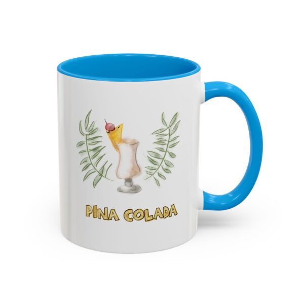 coffee mug with sky blue handle and watercolor artwork of pina colada drink with palm leaves