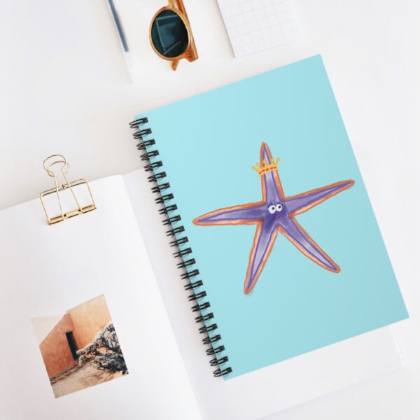 Cute purple starfish with golden crown printed on light aqua notebook cover