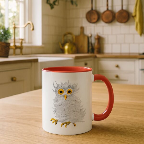 barn owl coffee mug with red handle sitting on a countertop in an English style country kitchen